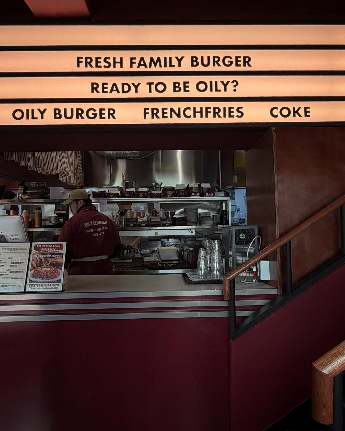 Open kitchen under the Oily Burger marquee